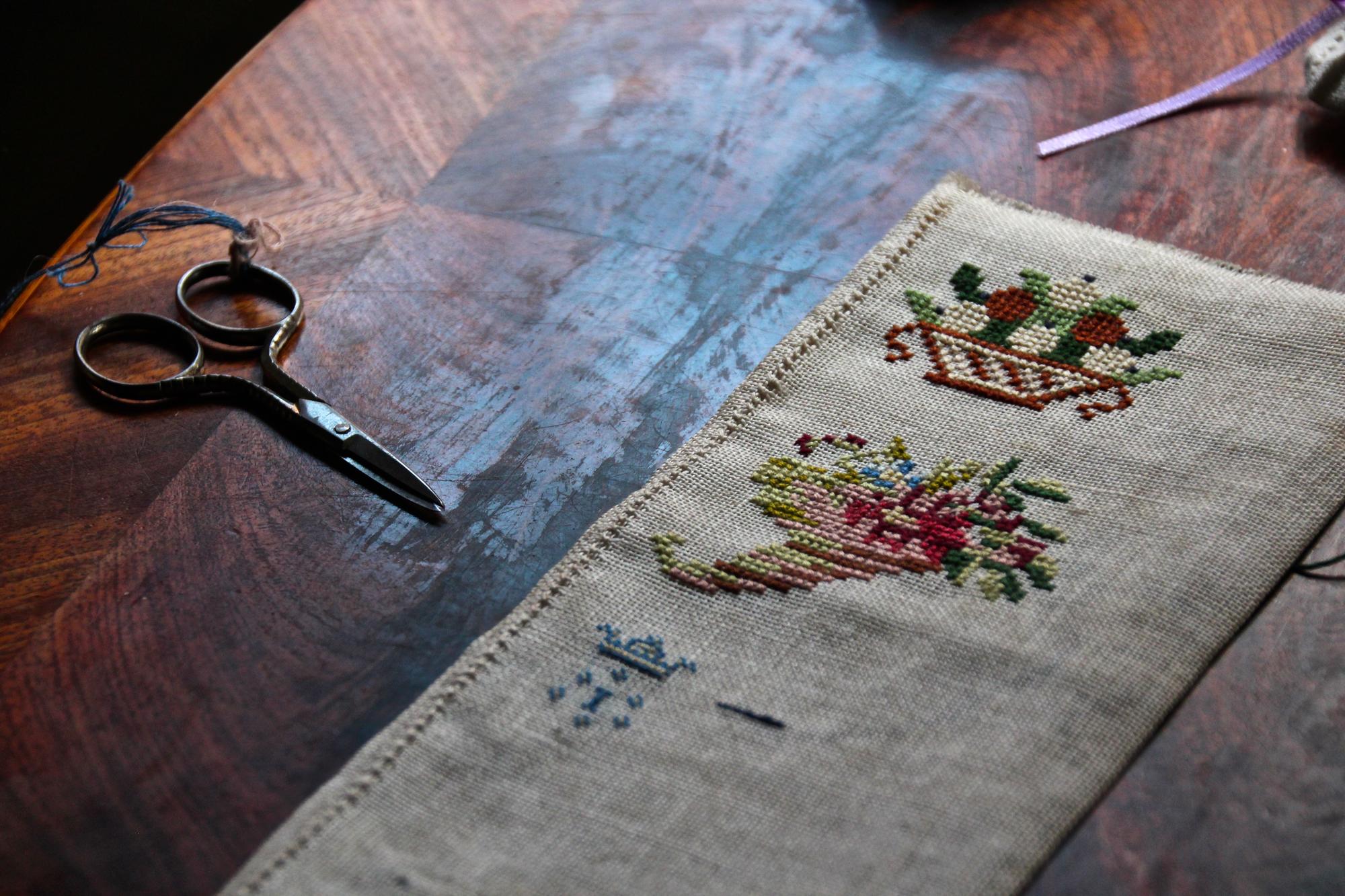 Editorial shot large embroidered textile on wooden table